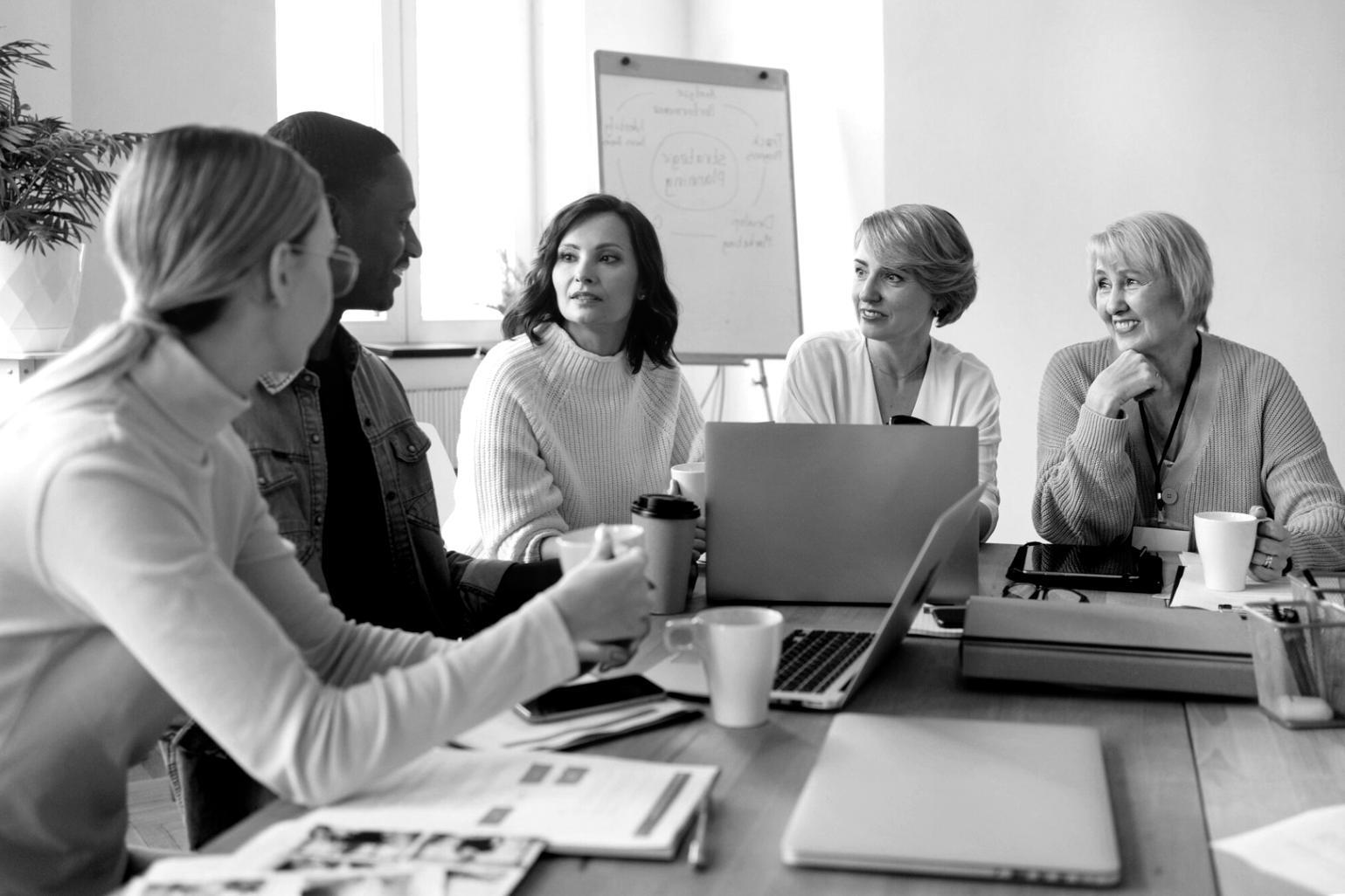 People working together on financial planning at a table with documents and calculators